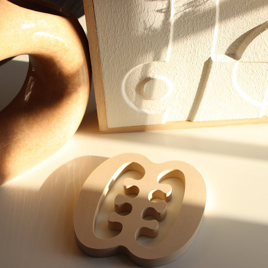 cream coloured Ese Ne Tekrema coaster on white background.