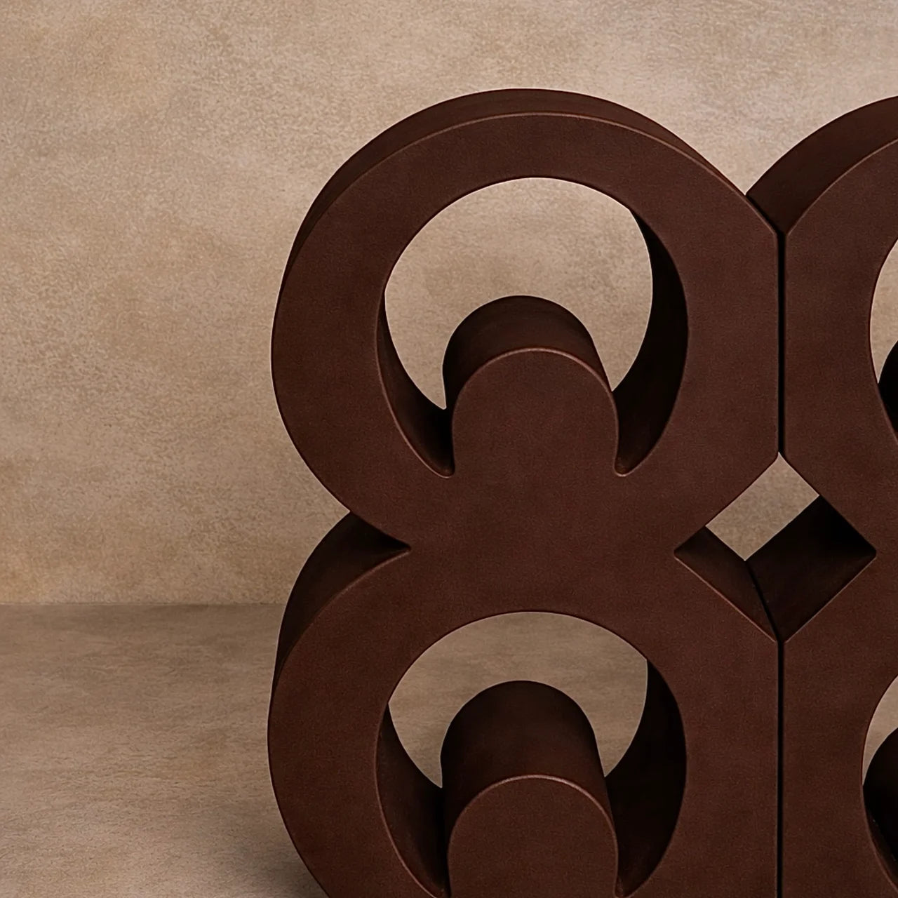 Brown close up of Mate Masie Adinkra bookends