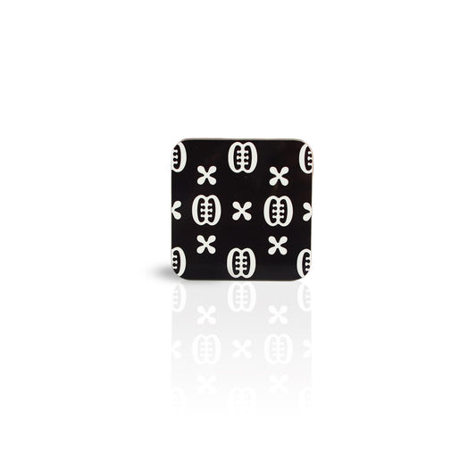 black coloured Ese Ne Tekrema adinkra wooden coaster on white background. 